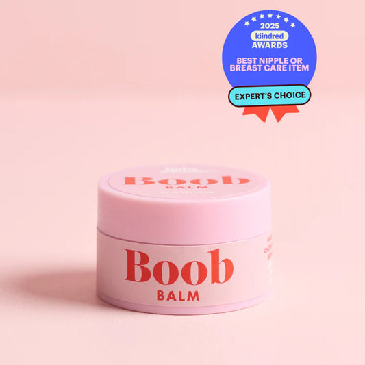 Pink 'Boob Balm' container with awards on a pink background