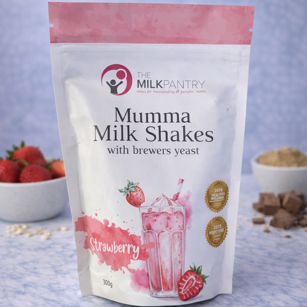 Package of Mumma Milk Shakes with strawberries and ingredients on a blue background