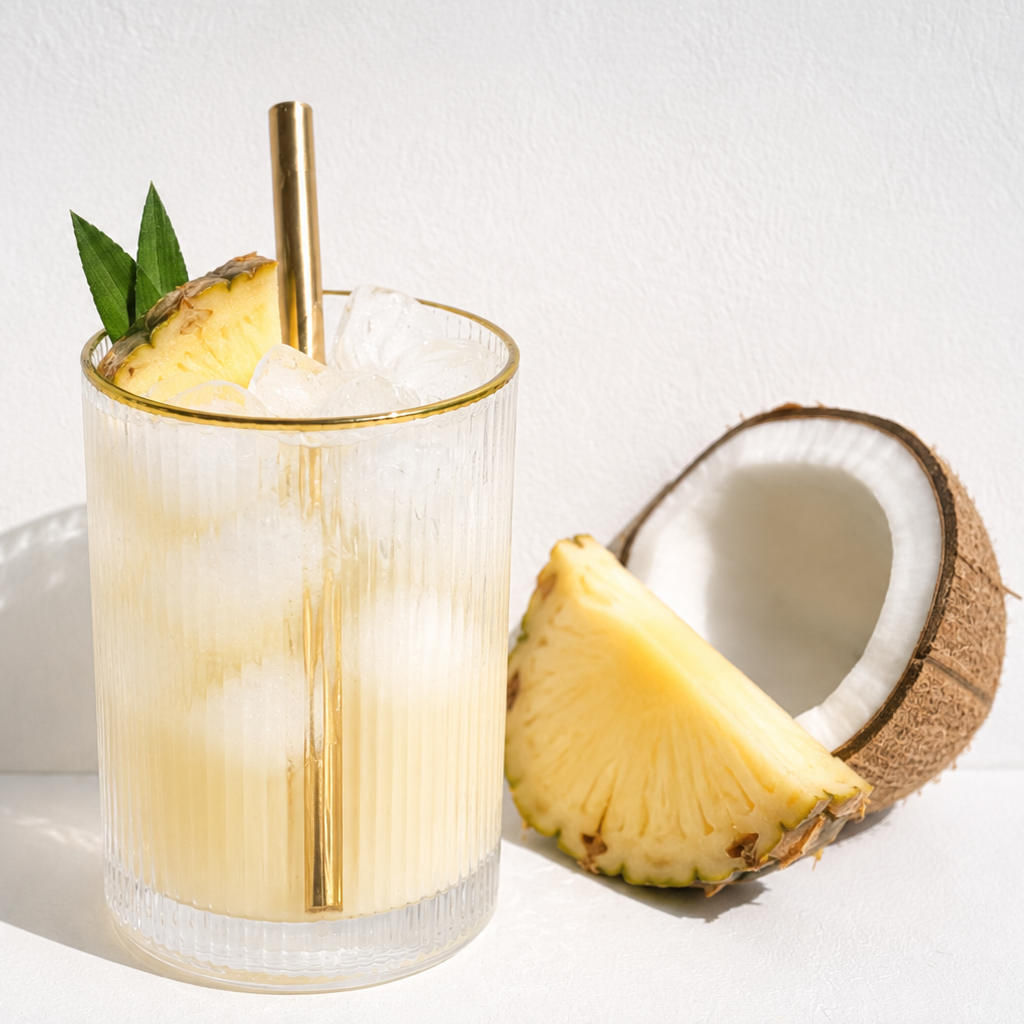 Pineapple and coconut cocktail with a straw on a white background