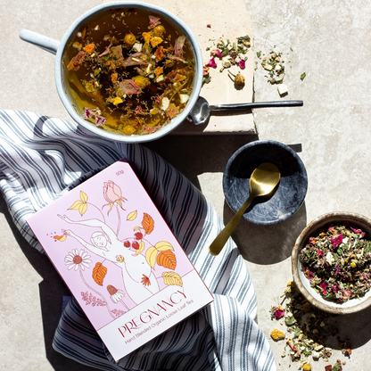 Tea-making setup with tea leaves, teacup, and tea package on a textured surface